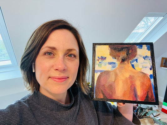 Louise holding a painting of a woman's back