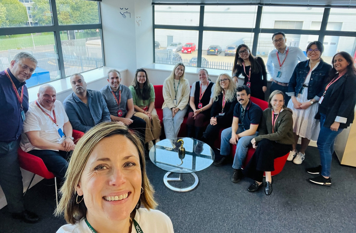 Group of people posing for a photo in a modern office setting